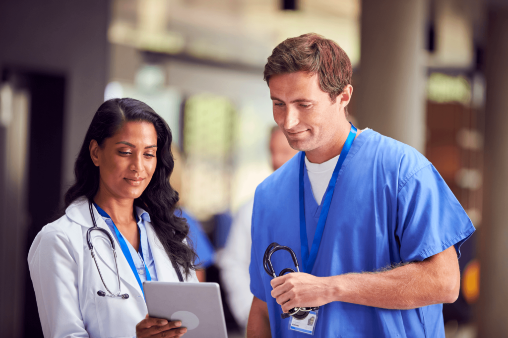 two-medical-staff-in-white-coats-and-scrubs